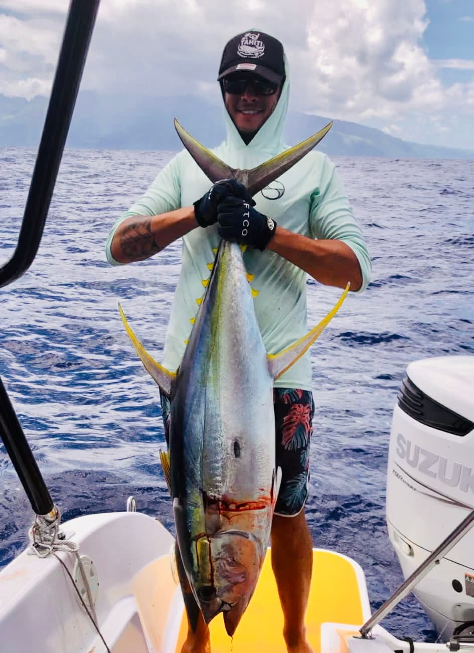 Fishing: Angler holding a yellowfin tuna caught offshore