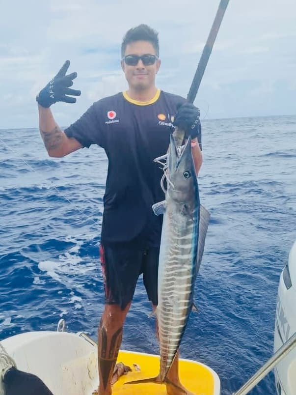 Fishing: Angler with a wahoo caught trolling