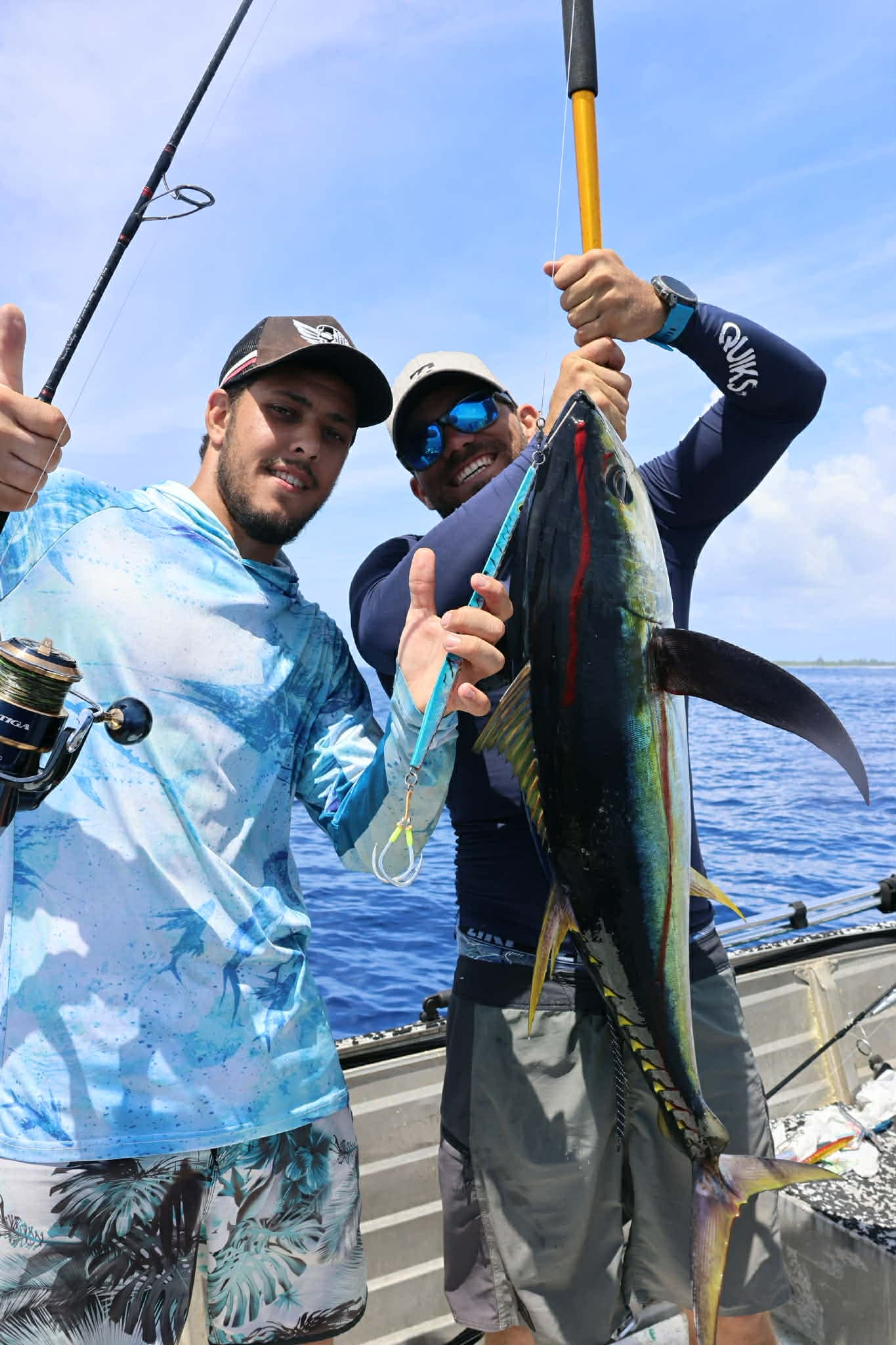 Fishing: Two anglers celebrating a yellowfin tuna catch